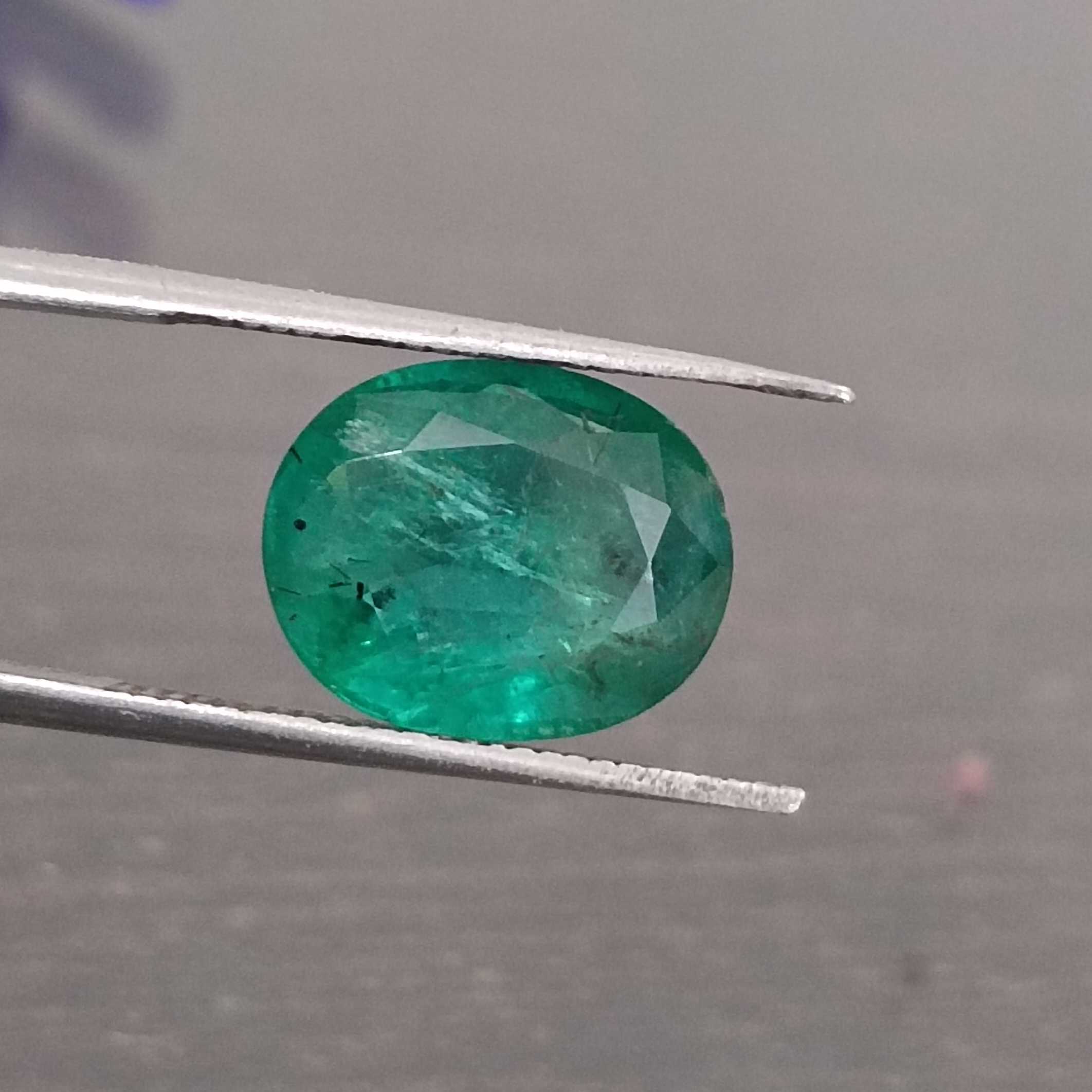 3.57ct deep shiny green oval step cut emerald