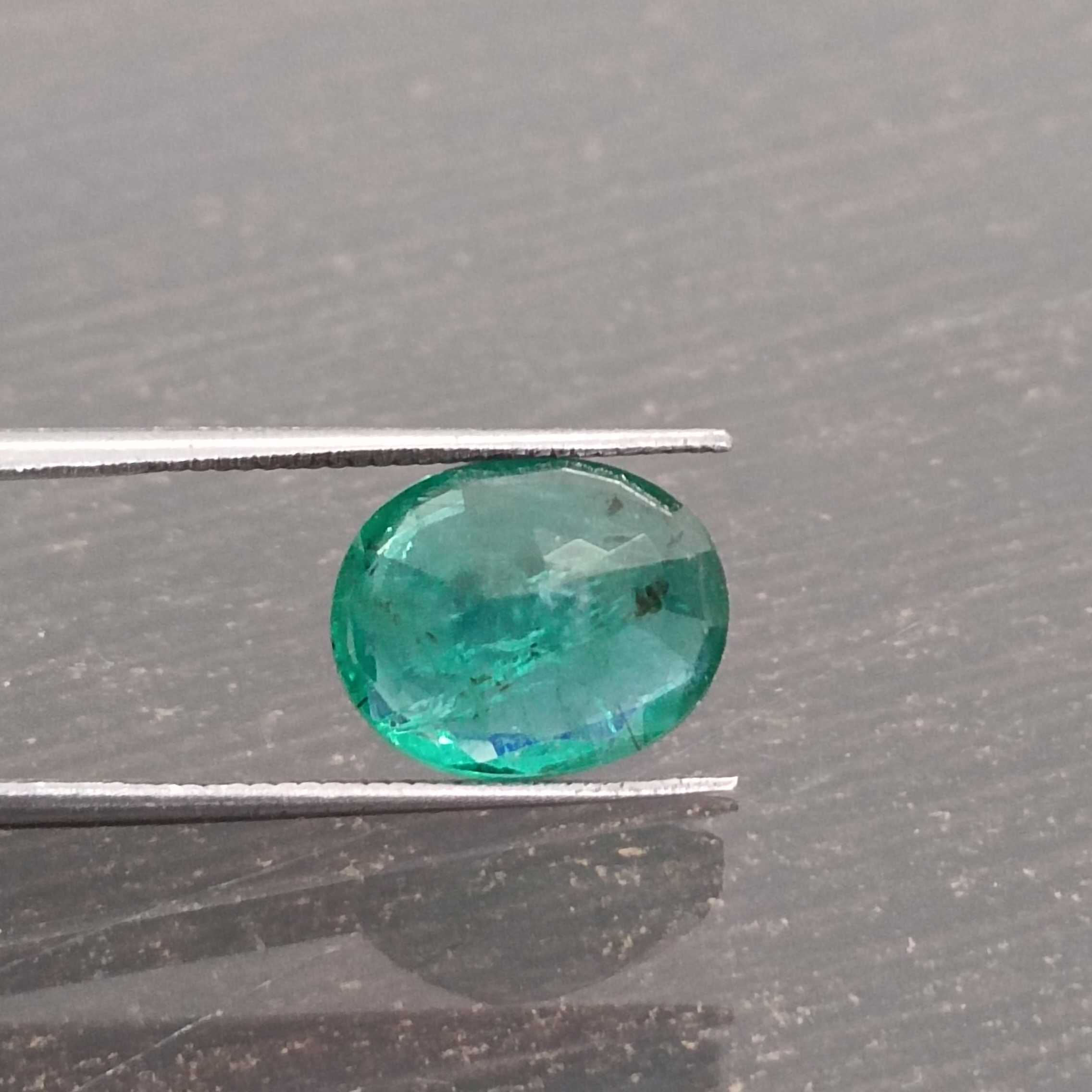 3.57ct deep shiny green oval step cut emerald