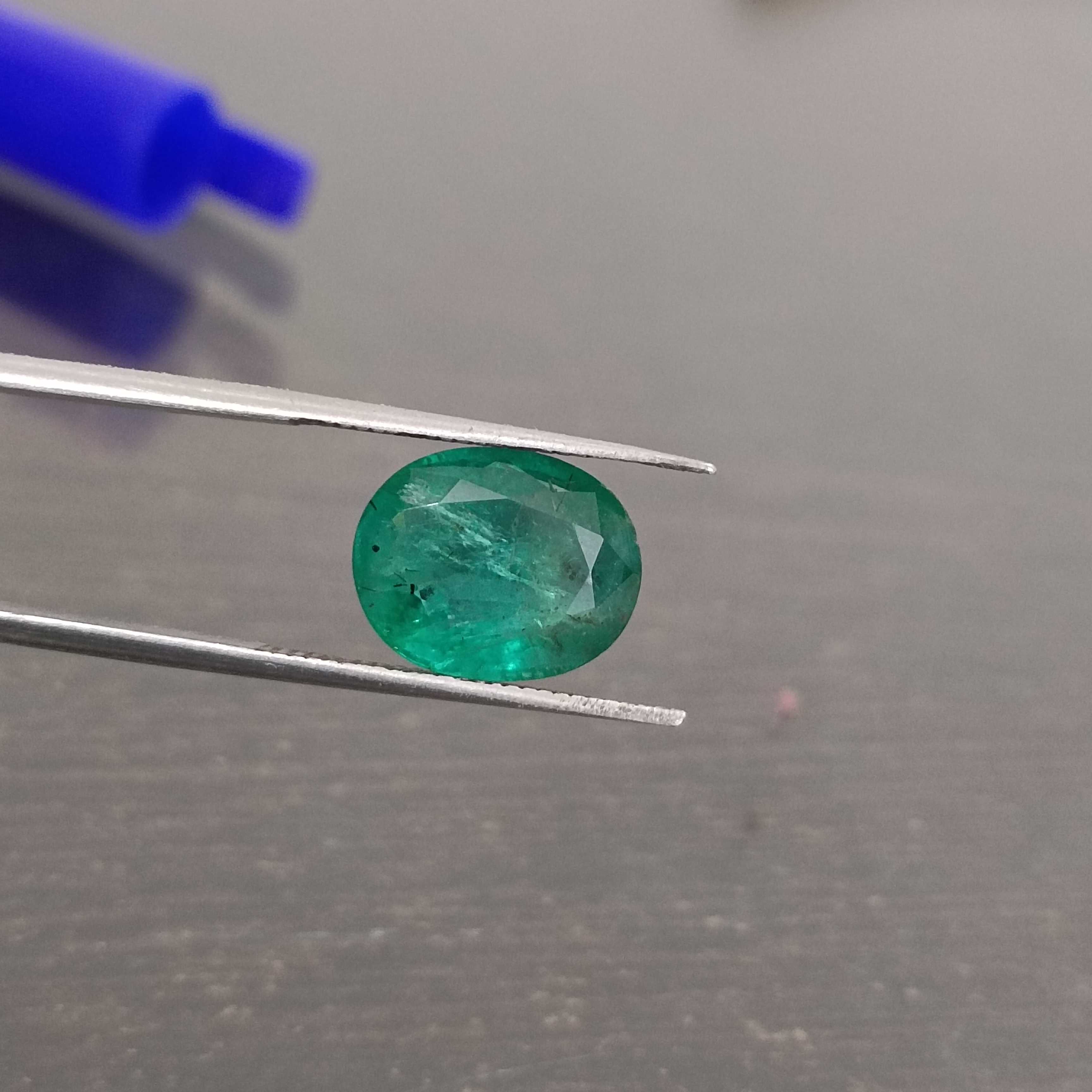 3.57ct deep shiny green oval step cut emerald