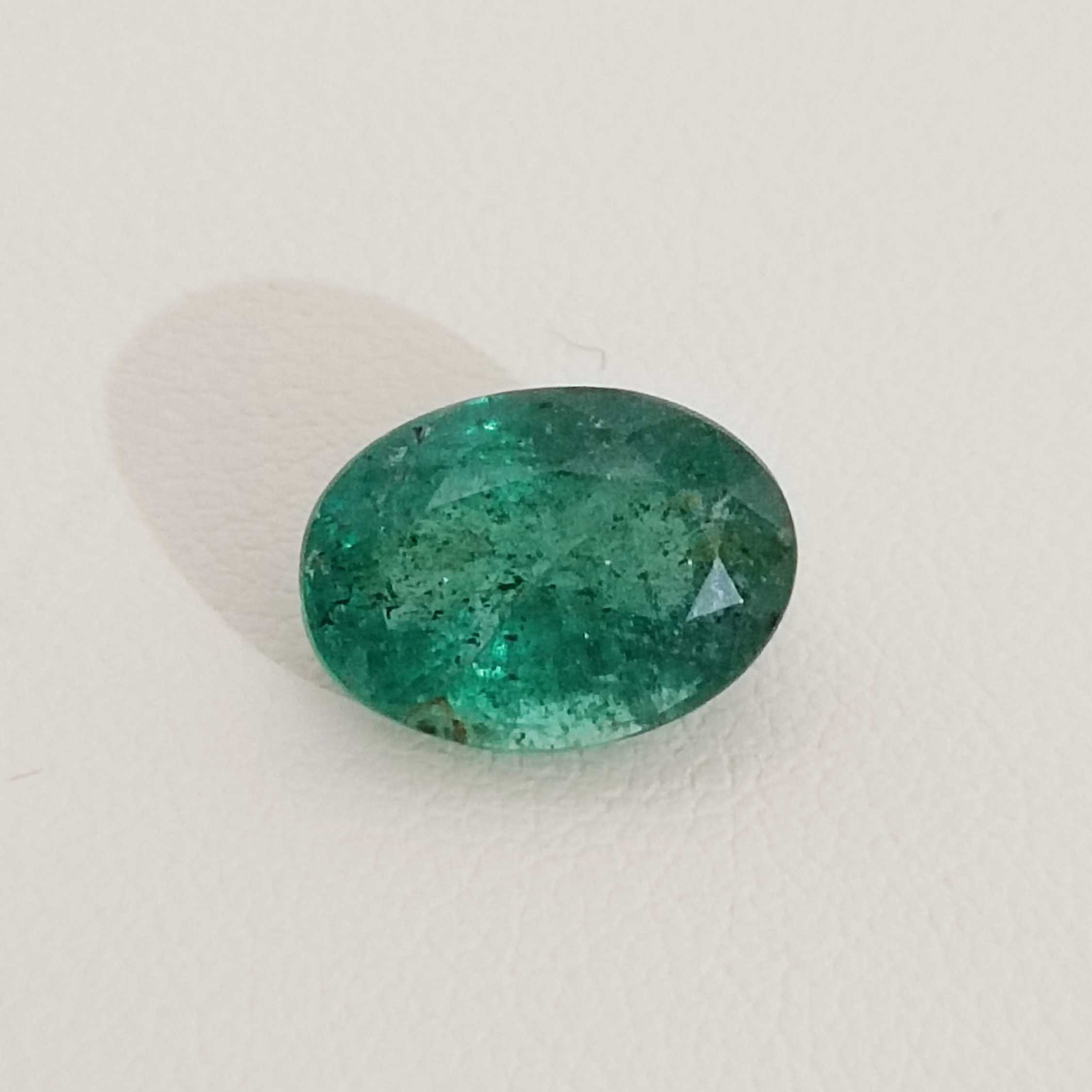 2.88cts bright very deep golden green oval cut Zambian emerald stone