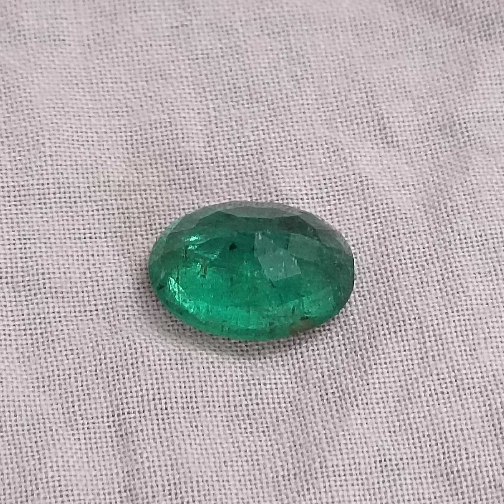 2.88cts bright very deep golden green oval cut Zambian emerald stone